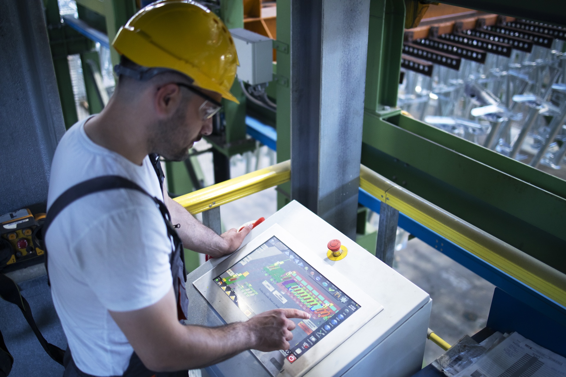 factory-worker-monitoring-industrial-machines-and-production-remotely-in-control-room.jpg