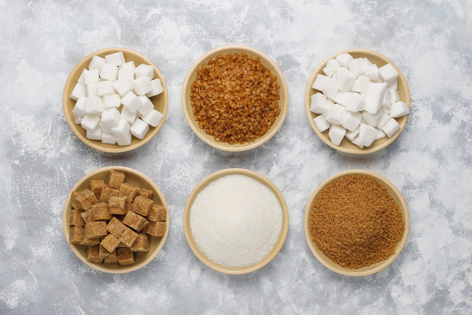 various-types-of-sugar-brown-sugar-and-white-on-concrete-top-view.jpg